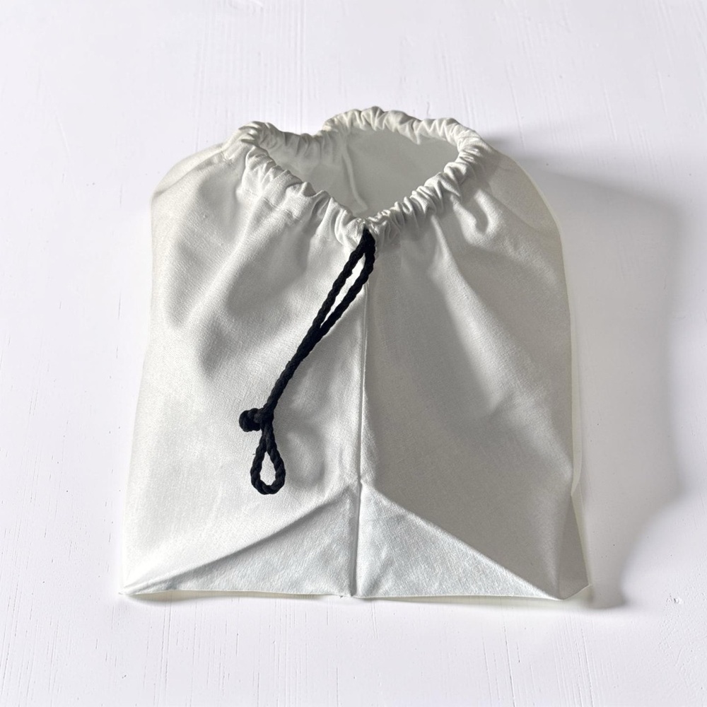 Authentic CHANEL White Bag with Black Drawstring - Picture 2 of 3